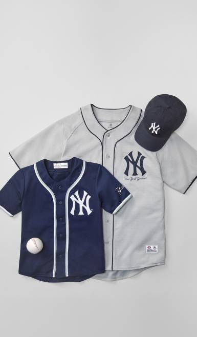 Image of two New York Yankees baseball jerseys & a baseball hat.