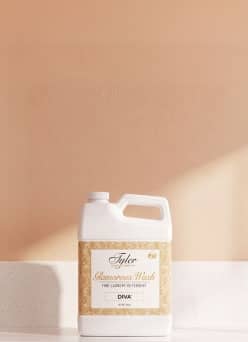 Tyler Glamorous Wash fine laundry detergent Diva jug on a countertop.