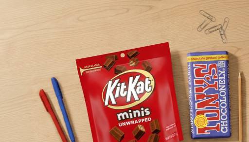 Two pens, paperclips, a pencil, a bag of Kit Kat Minis, and a Tony’s Chocolonely chocolate bar.