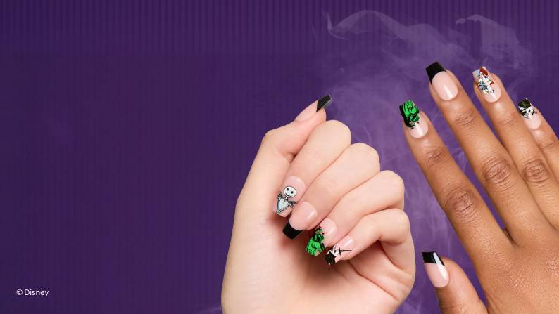 Disney nail art on two hands with black French tips and character designs on a light nude base. © Disney.