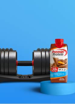 A Premier protein drink and set of weights.