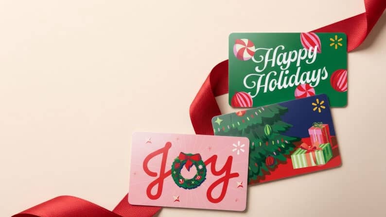 Three holiday gift cards on a red ribbon, reading: Happy Holidays, Joy, with a Christmas tree and presents design.