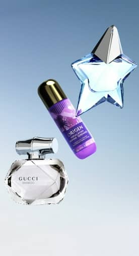 A product shot of a Gucci Bamboo perfume bottle, an Origen Himalayan Jasmine Serenade bottle, and a star-shaped Muglar perfume bottle.