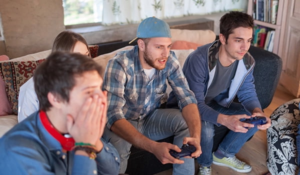 Video game system buying guide Group of people playing video games