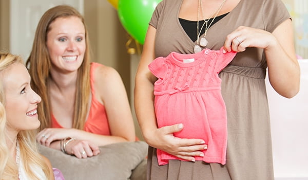 38277-157694_New_Image_Article_Hero_n_Spanish_Baby_n_Basics_of_maternity_clothes pregnant woman holding baby dress