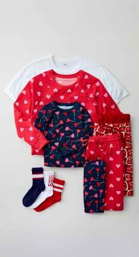 From nine dollars. Red, white and pink heart-printed pajama sets are next to multiple striped socks.