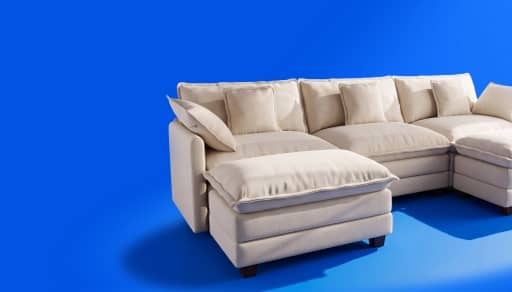 Beige sectional sofa with chaise and plush cushions.