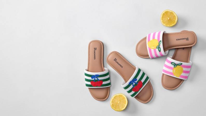 Women’s nautical striped slide sandals with print on strap; a red lobster, cherries and lemon. Right image, men’s brown leather two-strap sandals.