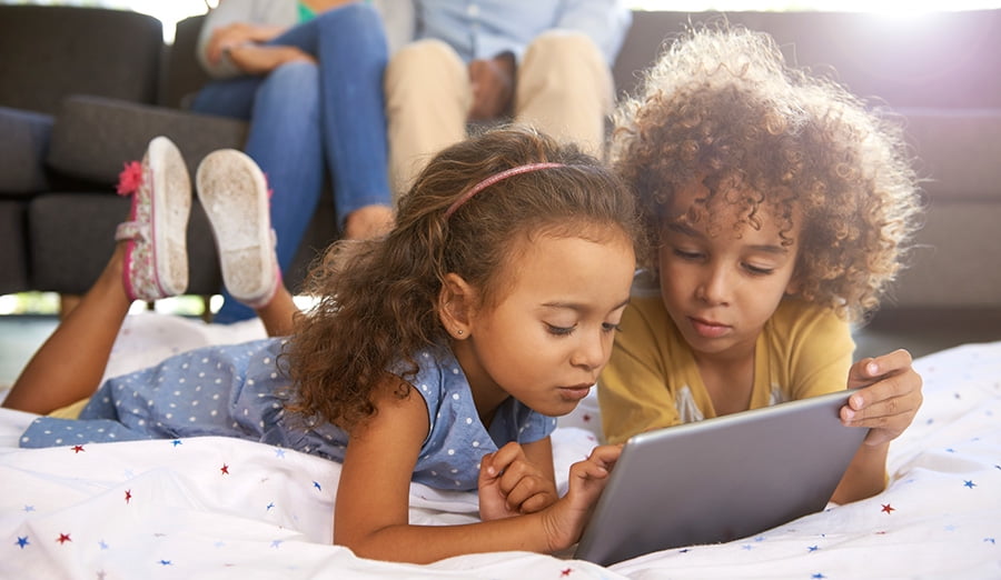 Two young girls playing on a tablet