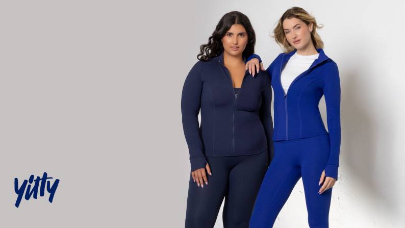 Two young women are shown wearing zip-up jackets and leggings. Yitty logo is seen.