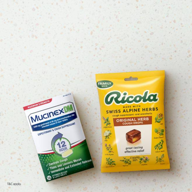 Image shows a box of Mucinex DM cough suppressant & a package of Ricola cough drops on a countertop.