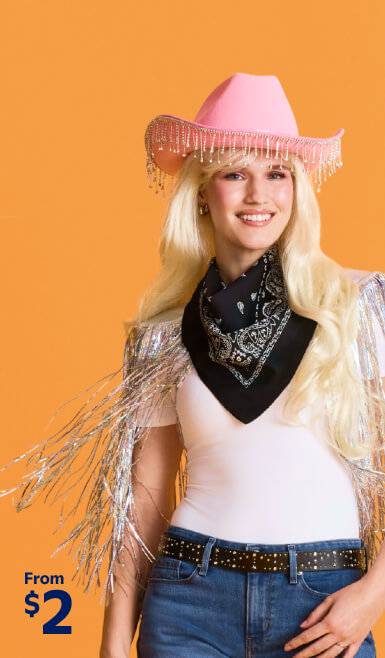 Image shows a person in a cowgirl Halloween costume, featuring a bedazzled hat, a blonde wig, a black bandana and a sparkly vest. From two dollars.