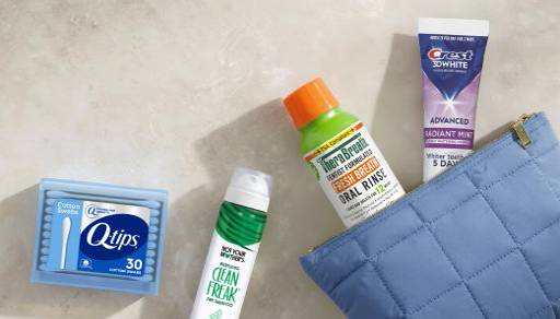 Cotton swabs, mouthwash and toothpaste next to a light blue travel pouch.