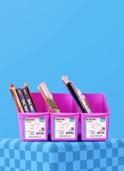 Purple organizers filled with notebooks on a blue background.