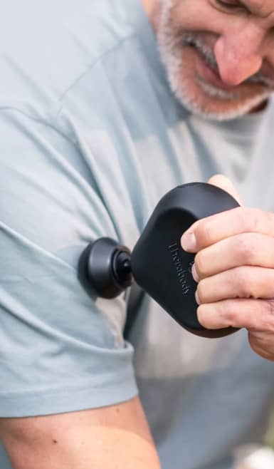 Image of a man using a Therabody massager on his arm. Fitness faves. Health tech. Shop now.