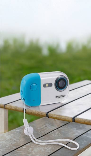 Image of a white and blue Vivitar camera sitting outside on a wooden table.