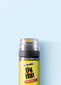 A canister of tire inflator on a blue background.