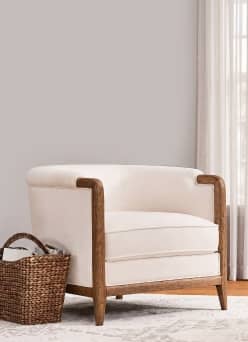 Image of cream & brown accent chair & a brown decorative basket next to it.