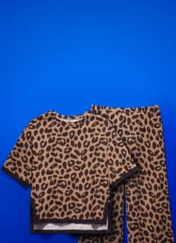 Leopard print short sleeve t shirt and matching pants set laid flat.