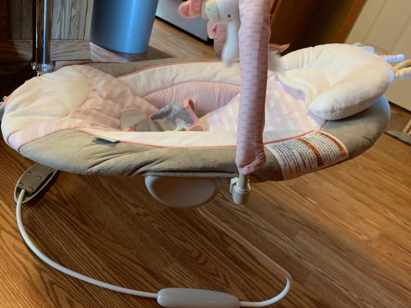 audrey cradling bouncer in pink