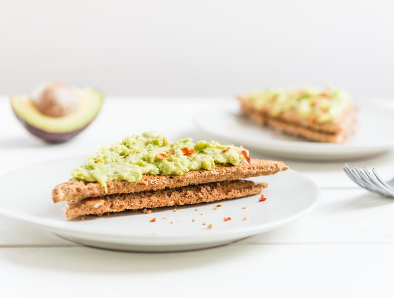 Avocado toast with salmon and chili flake and lemon