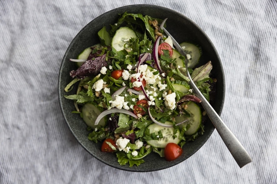 Farro and greens bowl with tahini sauce
