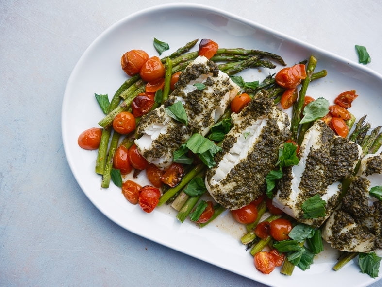 Pesto-encrusted cod with roasted tomatoes and asparagus