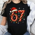 thumbnail image 1 of 100% Cotton Christmas Candy Cane Number 67 Santa Hat Lights Snowflakes Holiday T-Shirt For Women Men Unisex Festive Xmas Shirt, 1 of 5