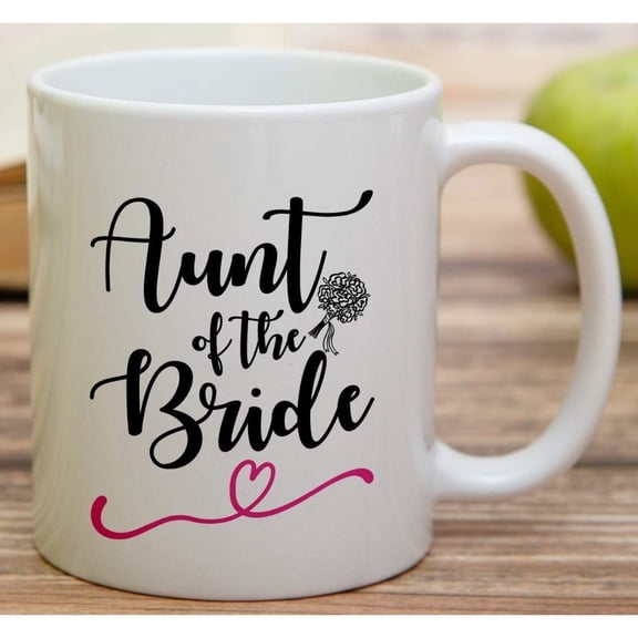 This 11oz ceramic coffee mug is specially designed for the bride's aunt. It features elegant cursive writing, floral designs and a pink heart motif. A humorous and sarcastic wedding present, it is al