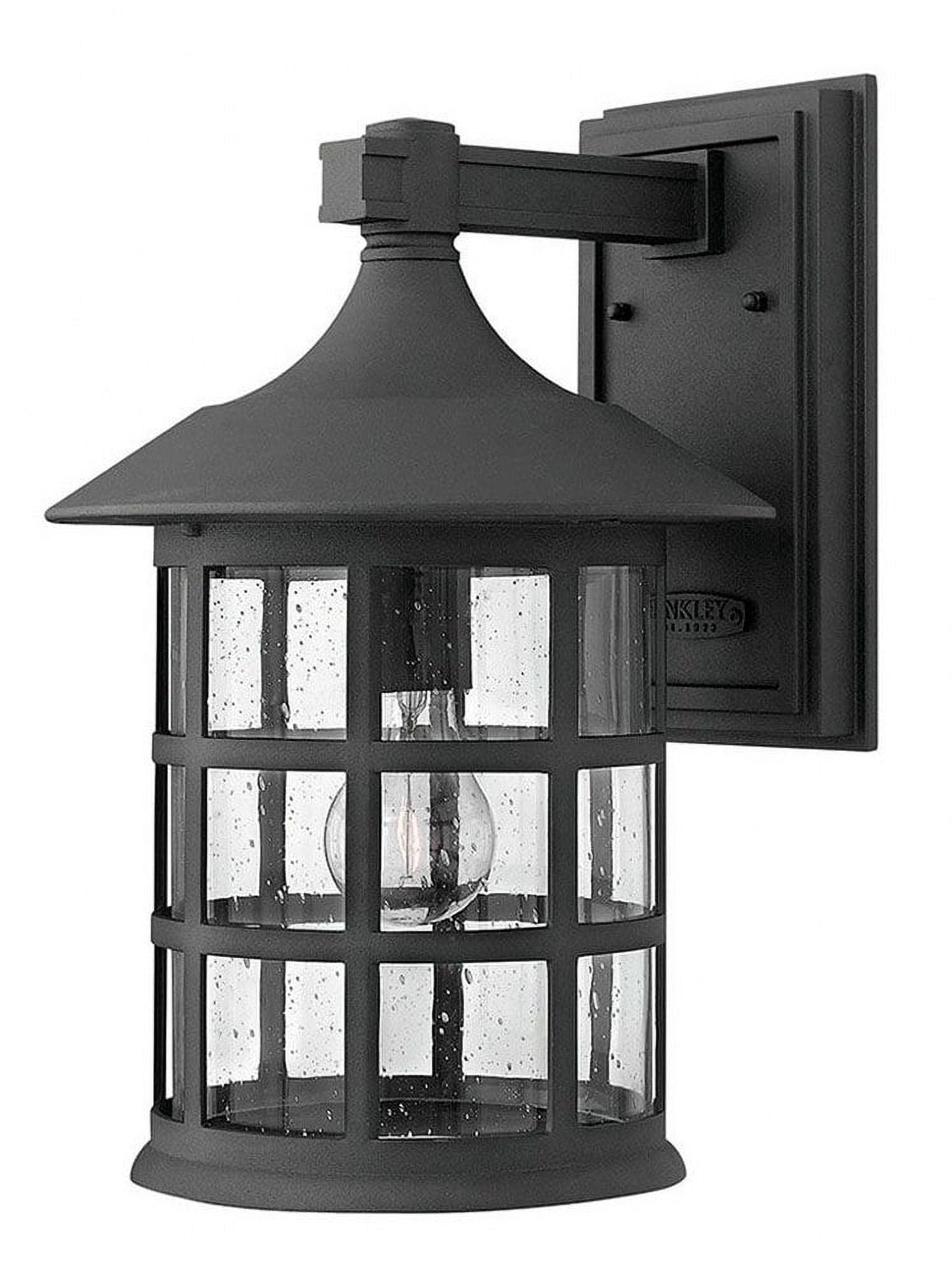 Freeport Black Cylinder 1-Light Outdoor Wall Sconce with Clear Seedy Glass