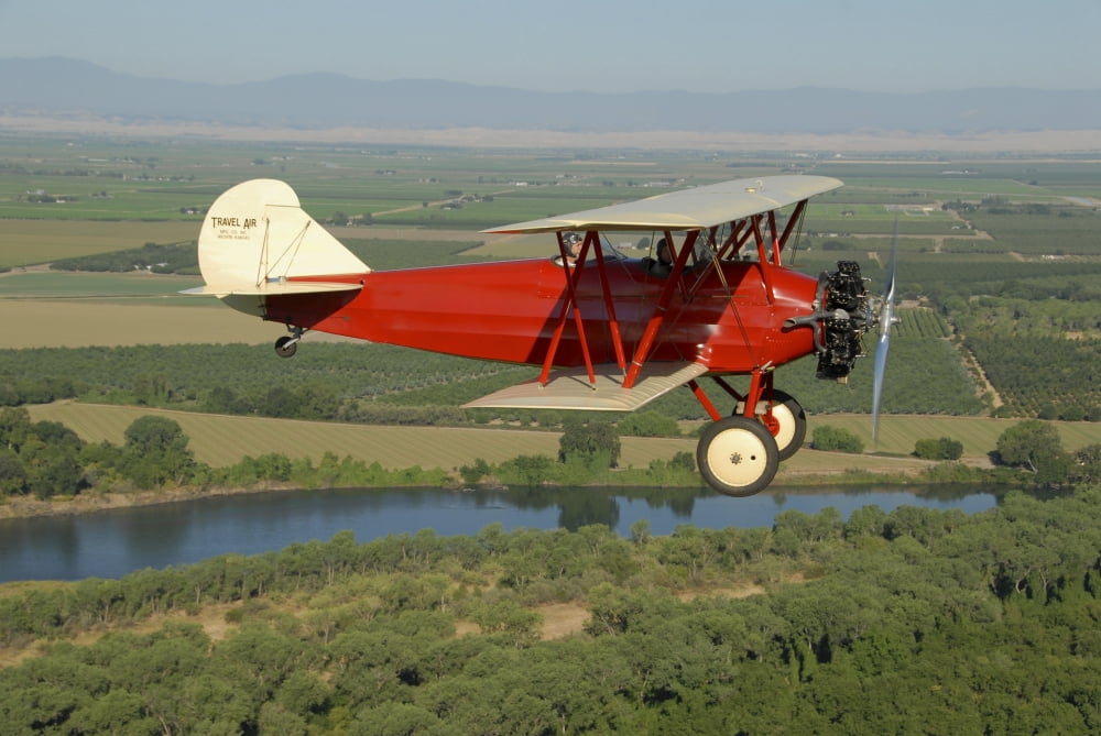 1929 Travel Air biplane over Sacramento River California Canvas Art - Phil WallickStocktrek Images (17 x 12)