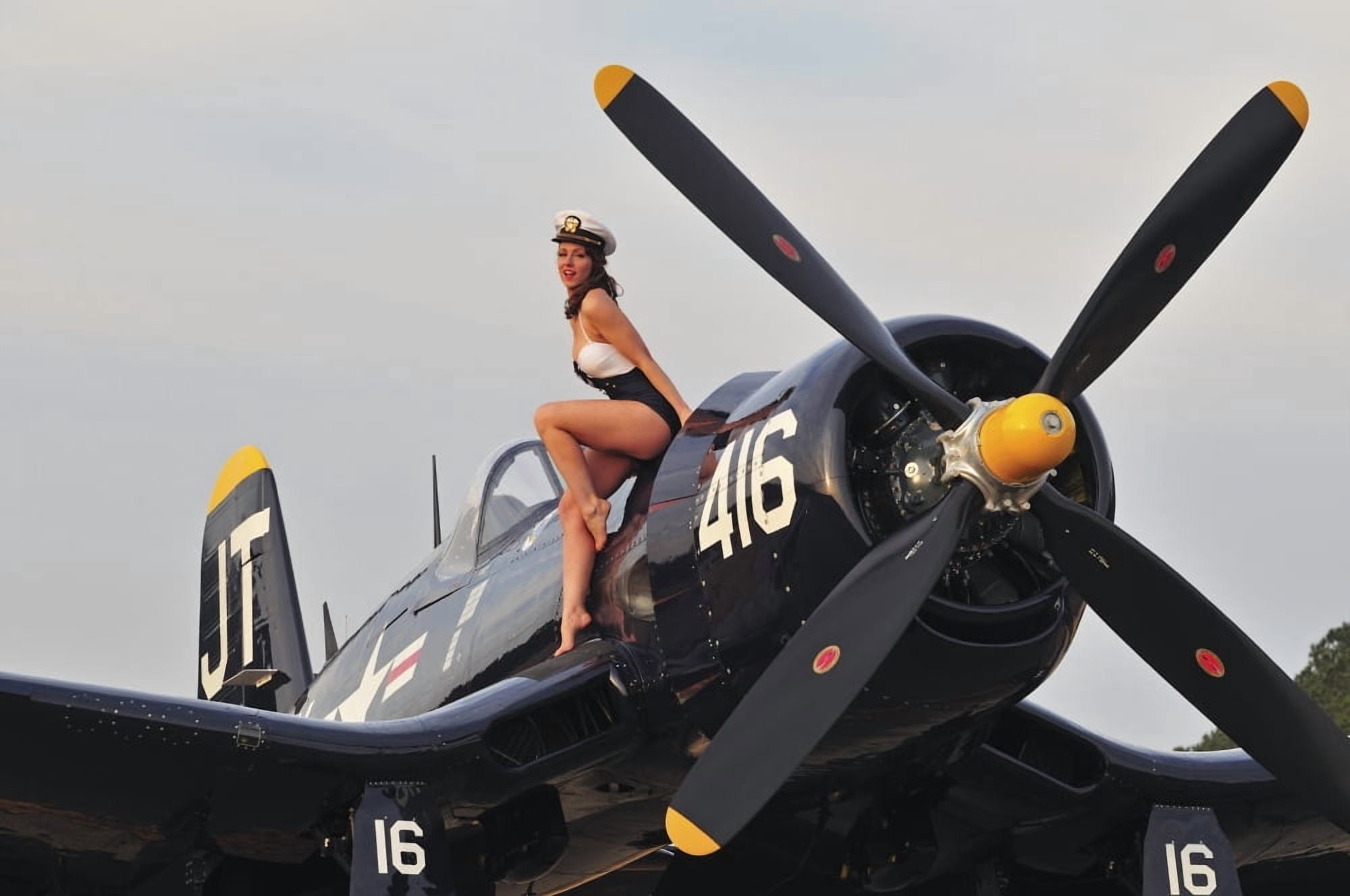 1940s style Navy pin-up girl sitting on a vintage Corsair fighter plane Canvas Art - Christian KiefferStocktrek Images (18 x 12)