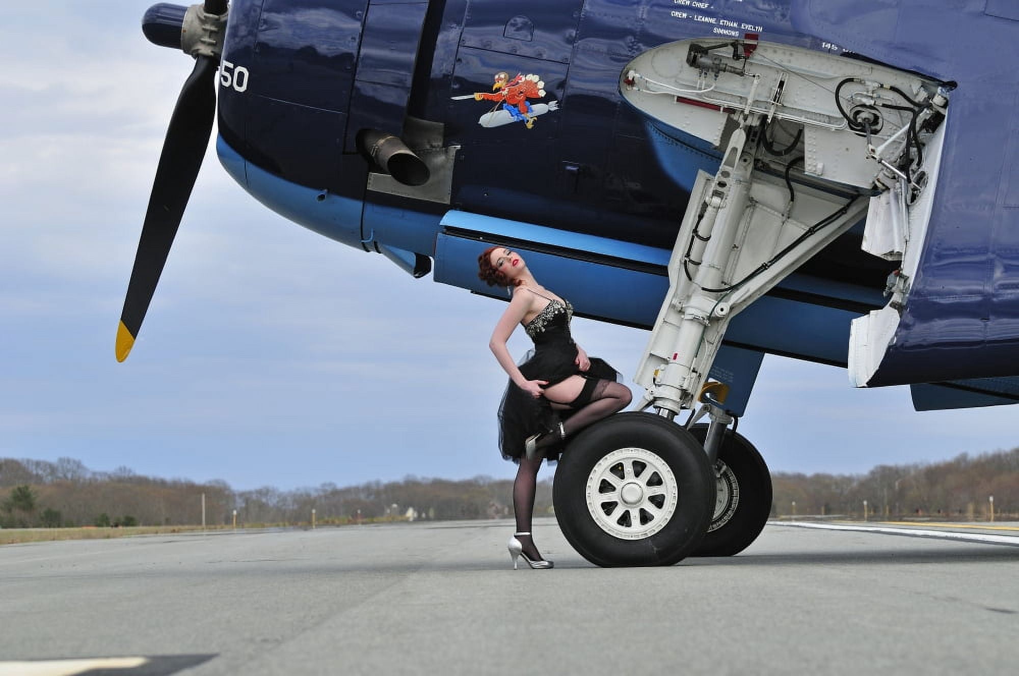 1940s style pin-up girl in cocktail dress posing in front of a TBM Avenger Canvas Art - Christian KiefferStocktrek Images (18 x 12)