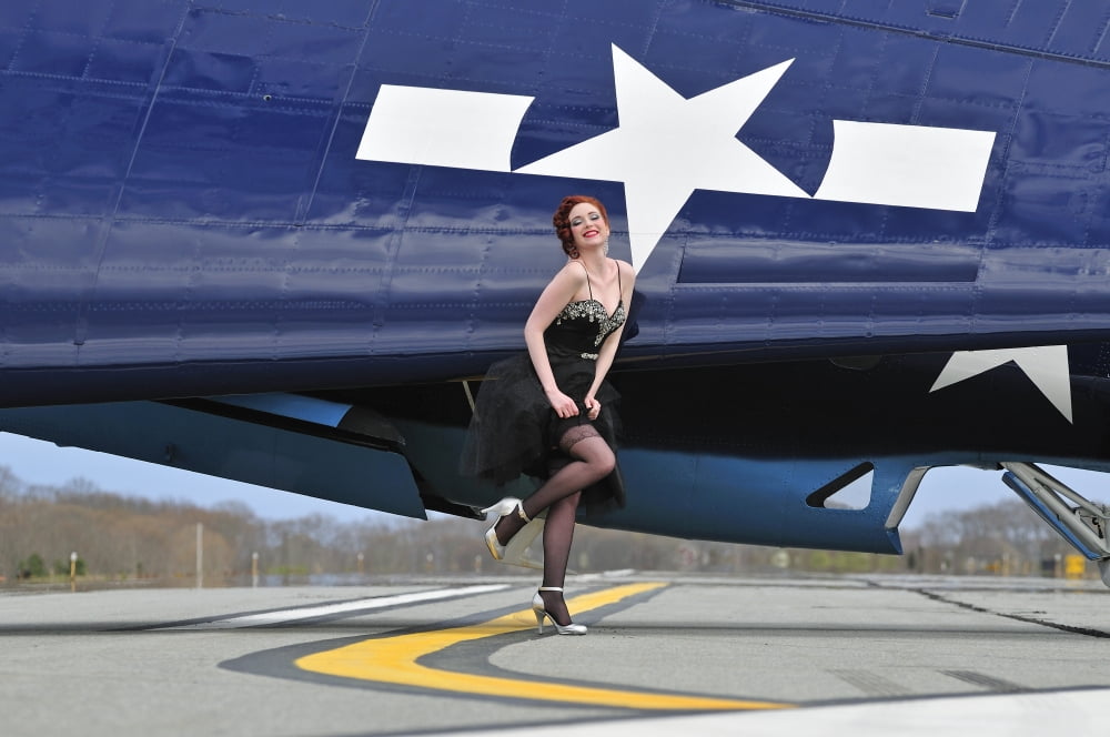 1940s style pin-up girl in cocktail dress posing in front of a TBM Avenger Canvas Art - Christian KiefferStocktrek Images (18 x 12)