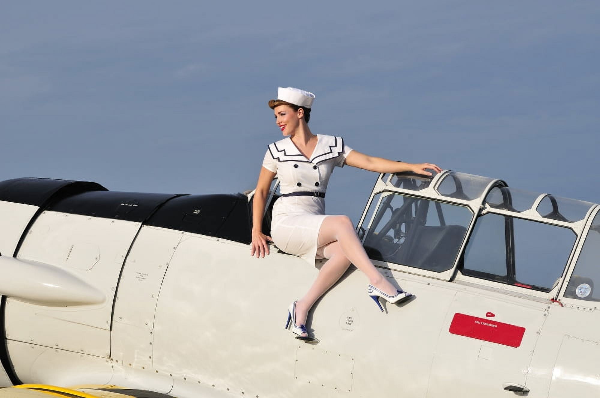1940s style pin-up girl sitting outside the cockpit of a T-6 Texan Canvas Art - Christian KiefferStocktrek Images (35 x 23)