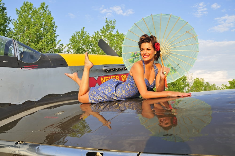 1940s style pin-up girl with parasol on a vintage P-51 Mustang Canvas Art - Christian KiefferStocktrek Images (35 x 23)