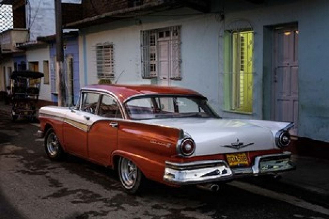 1950s era Ford Fairlane and colorful buildings Trinidad Cuba Canvas Art - Adam Jones DanitaDelimont (39 x 26)