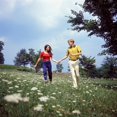 thumbnail image 1 of 1960s-1970s Young Teenage Couple Holding Hands Running Through Field Of Queen Anne'S Lace Wild Flowers Print By Vintage, 1 of 1