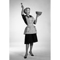 thumbnail image 1 of 1960s Excited Woman Housewife In Apron Black Dress And High Heels Looking At Camera Holding Up Mixing Bowl And Kitchen, 1 of 1
