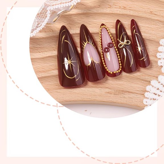 A 24-piece push-on manicure set made of reusable acrylic with 3D gold line, stars and bows, hearts and cherries designs. The red full coverage manicure is perfect for women.