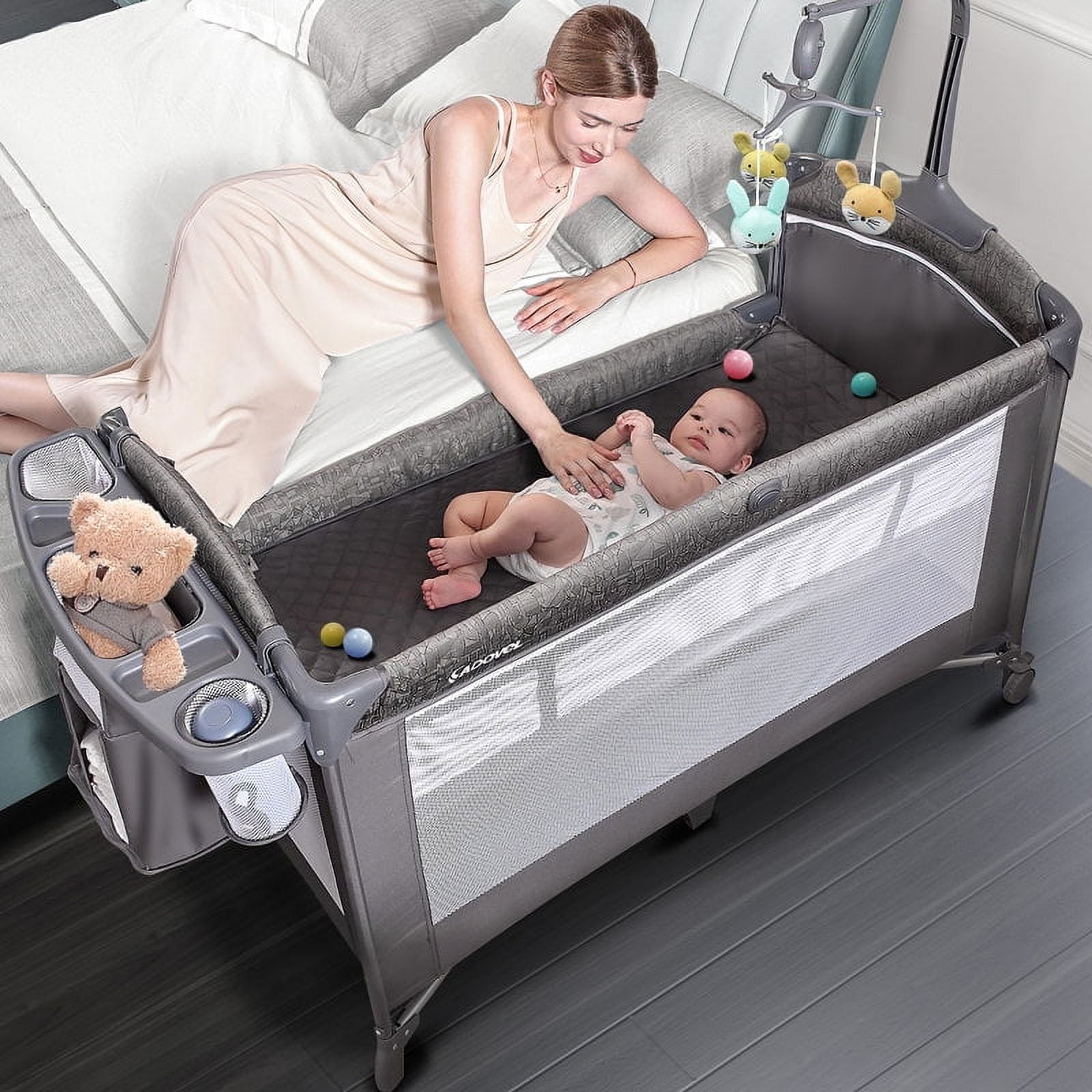 3-in-1 Bedside Bassinet, Play Yard & Diaper Changer, suitable for newborns to toddlers aged 0-2. Comes with mattress, mosquito net, bottom diaper storage compartment and toy bar.