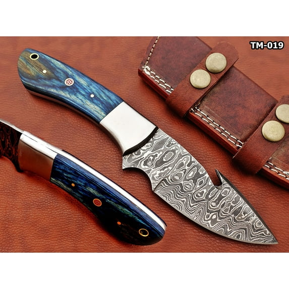 9.5" long Damascus steel Gut hook skinning knife, Full tang Rain drop pattern straight back blade, Blue colored wood scale with steel bolster, includes Cow hide Leather sheath (Blue Wood)