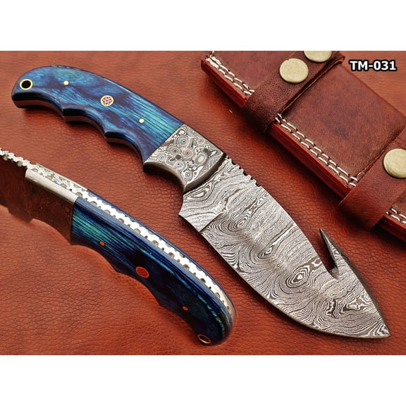 9.5" long Damascus steel Ladder pattern skinning knife, Full tang drop point Gut hook blade, Finger serrated Blue colored wood scale, includes Cow hide Leather sheath (Blue Wood)