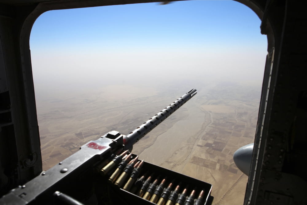 A 50 caliber machine gun aims outboard of a CH-53E Super Stallion Canvas Art - Stocktrek Images (35 x 23)