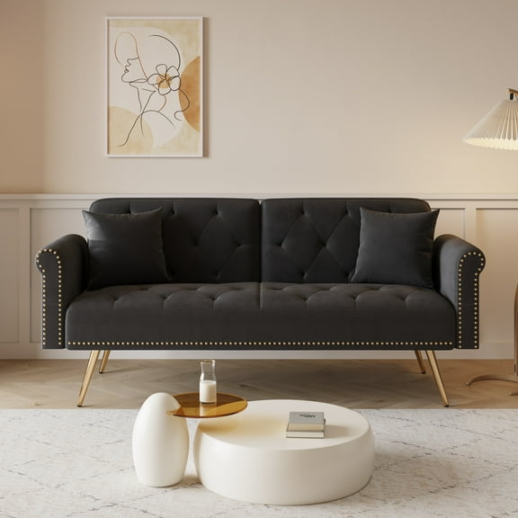 A 69.7-inch-long sofa bed covered in Black velvet fabric, featuring nail head trim and accompanied by a matching throw pillow