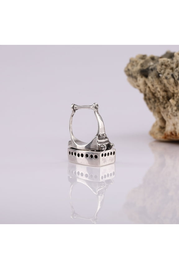 A 925 Sterling Silver ring in the form of an antique cast iron.