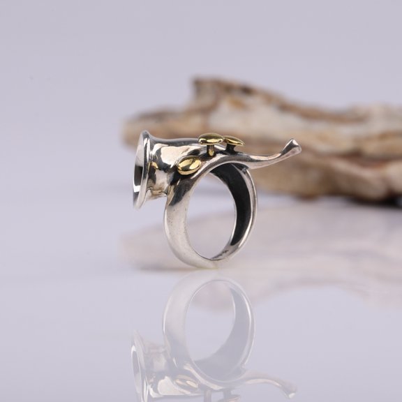 A 925 sterling silver ring in the form of a French horn with brass keys