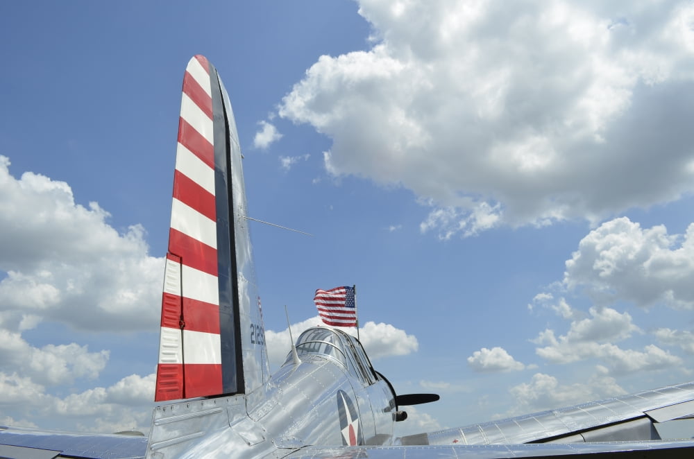 A BT-13 Valiant trainer aircraft with American Flag Canvas Art - Stocktrek Images (35 x 23)
