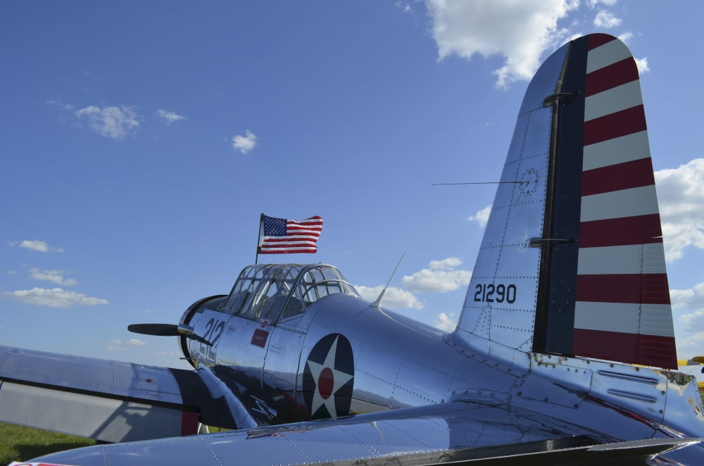 A BT-13 Valiant trainer aircraft with American Flag Canvas Art - Stocktrek Images (35 x 23)