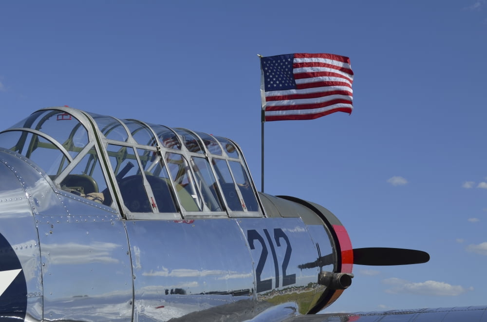 A BT-13 Valiant trainer aircraft with American Flag Canvas Art - Stocktrek Images (35 x 23)